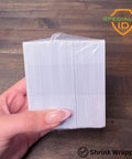 Top Shelf Blank Composite ID Cards For Retransfer Printers 30 Mil Pvc Pet Blend Cr80 Heavy Duty White Badge Stock held in hand.