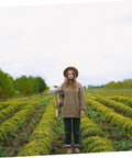 Person in garden holding a Two Pack Steel Hand Hoe Set For Weeding And Gardening, Manual Garden Tools For Loosening Soil And Uprooting Weeds.