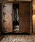 Vintage Antique Cast Iron T Hinges For Cabinet Doors 5 Point 3 Inch on a rustic wooden wardrobe with clothing inside.