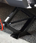 2 Ton Car Scissor Jack With Labor Saving Ratchet Wrench lifting a vehicle, adjustable lift from 3.85 to 17.4 inches, in use.