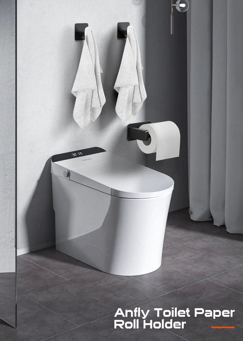 Self Adhesive RV Toilet Paper Holder With Two Hanging Hooks For Campers No Drill Wall Mount Black Finish Ideal For Bathroom Kitchen Or Bedroom Durable Rustproof Stainless Steel Build For Lasting Use installed on bathroom wall near toilet.