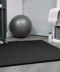 Interlocking EVA Foam Gym Mats Set With 20 Puzzle Tiles laid on floor in home gym with dumbbells and exercise ball