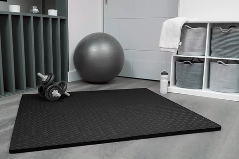 Interlocking EVA Foam Gym Mats Set With 20 Puzzle Tiles laid on floor in home gym with dumbbells and exercise ball