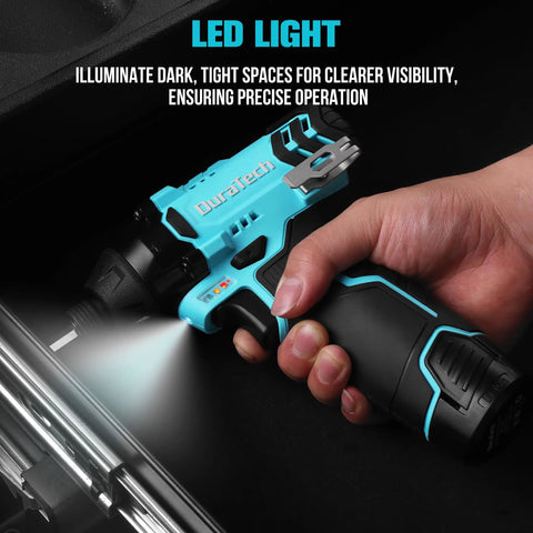 Hand holding 12V Cordless Impact Driver Kit with 885 in lbs torque, LED light illuminating workspace, close-up view