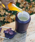 Half Gallon Stainless Steel Water Jug With Ceramic Lined Interior Double Wall Insulated Cooler Bottle being filled with beverage.