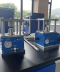 Top Drawer Manual Coin Cell Crimper For CR2020 And CR2032 Batteries features heavy duty press and pressure gauge setup on workbench.