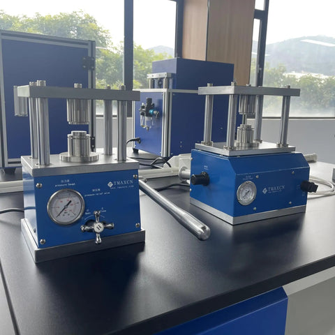 Top Drawer Manual Coin Cell Crimper For CR2020 And CR2032 Batteries features heavy duty press and pressure gauge setup on workbench.