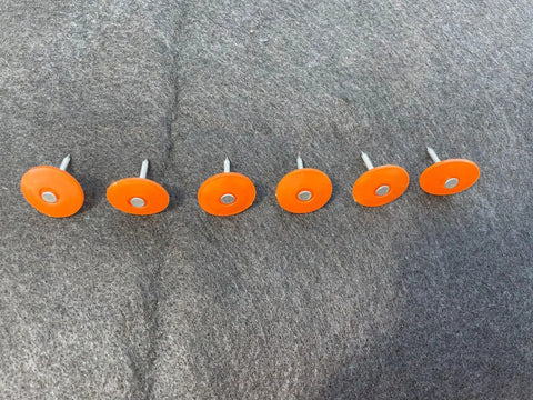 Pro Grade Plastic Cap Roofing Nails With Hella Secure Ring Shank And Tough Electro Galvanized Steel for roof underlayment, visible orange caps.