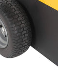 Close-up of heavy duty electric powered tugger wheel, black tire on metal rim, used for moving heavy trailers and carts at airports.