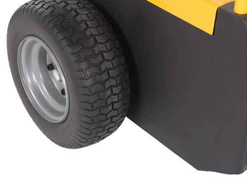 Close-up of heavy duty electric powered tugger wheel, black tire on metal rim, used for moving heavy trailers and carts at airports.