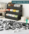 Three Layer Stackable Tea Bags Organizer Made From Bamboo With Large Capacity Go To Display Rack For Pantry Kitchen Office Coffee Station And Bars Restaurants Black holding tea bags and pods on a countertop
