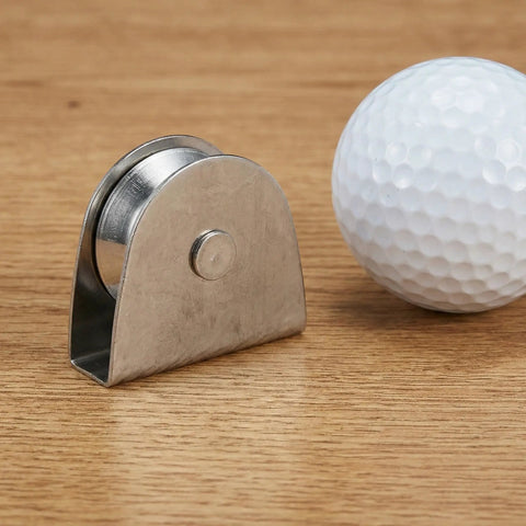 Heavy Duty V Groove Pulley Wheel 304 Stainless Steel Flagpole Riser Kit on wood surface with a golf ball for scale.