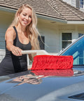 Person using All In One Car Duster Detailing Kit with Plastic Handle Includes Standard Duster and Mini Dash Duster Red Model 62445 on car hood