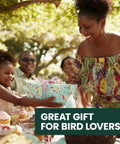 Family enjoying outdoor celebration with wrapped gift on table, text 'Great Gift for Bird Lovers' in corner.