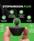 Close-up of silicone StopShroom Plug held by hand, labeled features - easy to clean, BPA free, fits bathroom sink drain.