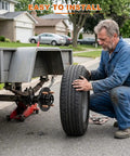 Man installing a tire on a trailer, showcasing Heavy Duty 4 Lug Trailer Hub Kit For 2000 Lbs Boat Rigs with 4x4 inch bolt pattern.
