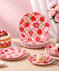 Totally Dope Pink Plaid Strawberry Print Disposable Paper Plates 60 Pack With 9 And 7 Inch Sizes on table with cake and desserts.