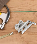 Heavy Duty Stainless Steel Sliding Door Pulleys With Smooth As Butter Bearings For Barn Door Wheels and Closet Track System displayed with tools.