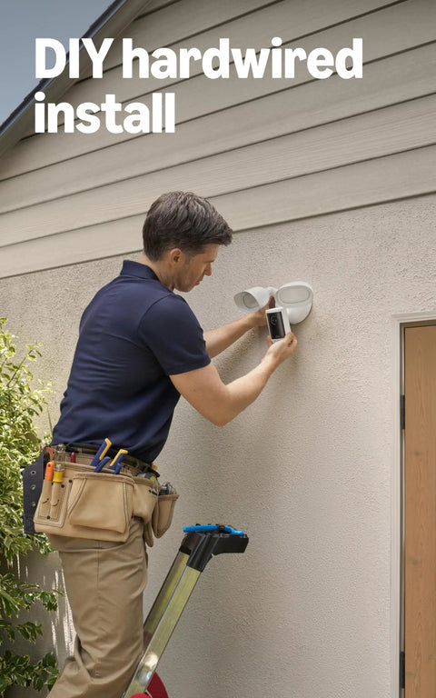 Man installing Floodlight Cam Pro Wired Security Camera With Retinal 4K Video Wide Angle View 10x Enhanced Zoom 2000 Lumen