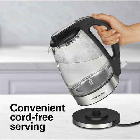 Person holding 1.7L Electric Kettle With Fast Boil 1500W, Water Boiler And Heater, featuring LED indicator and cordless base.