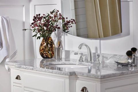 Elmhurst Two Handle Widespread Bath Faucet Chrome Finish With ADA Compliant Push Pop Up Drain shown on marble vanity
