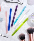Glass Cuticle Pusher Manicure Stick with slanted side and pointed end in assorted colors on a towel, pro-grade tool.