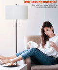 Modern Two Light Floor Lamp With Dual Pull Chains Tall Standing Light In Brushed Nickel Finish And White Lampshade next to a woman reading