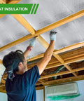 Man installing Heavy Duty Aluminum Radiant Barrier Insulation Roll 24 By 50 Feet in attic rafters for heat blocking.