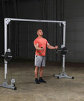 Beefy Heavy Duty Cable Crossover Machine For Home Gym Functional Trainer featuring dual high and low pulleys with user exercising.