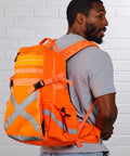 Man wearing Hi Vis Orange Safety Backpack With Reflective Panels, Adjustable Hard Hat Holder, and Bottle Holders for construction use.
