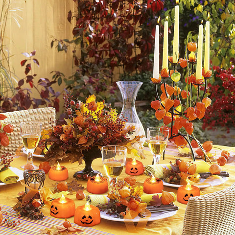 Festive autumn table setting with Lit Green LED Flameless Candles Pack 24 Pieces With Realistic Flicker Battery Powered Tea Lights.