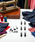 GoTo 12-Piece Black Zipper Puller Repair Kit With Detachable Sliders on table with sewing machine and fabric.
