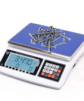 Digital Counting Scale For Parts And Coins With 1g Precision 30kg 66lb Capacity Multiple Unit Options In Kg G Lb Perfect For Inventory Counting QA Checks And Packaging In Warehouses displaying screws on the platform