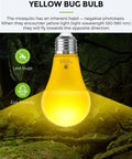 Yellow bug bulb with eco-friendly design for less bugs, emitting light in forest setting. Suitable for dusk to dawn outdoor use.