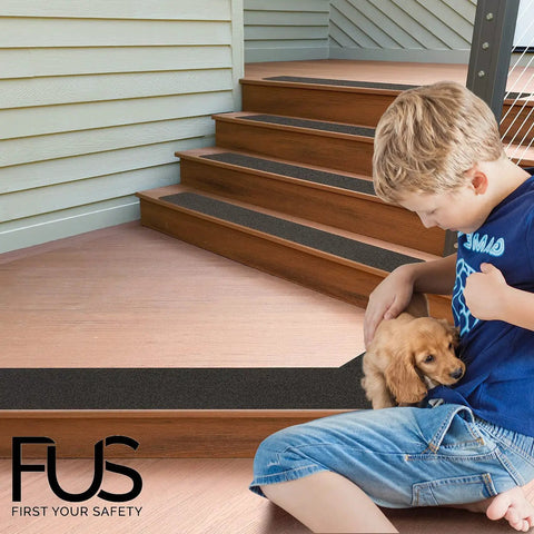 Child sitting near stairs with No Slip Stair Treads With 80 Grit PET Non Skid Tape For Indoor Outdoor Steps 6 by 30 inches Black