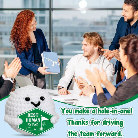 Smiling team applauding with Crochet Golf Ball Accessories Gift Set For Men displaying 'Best Human By Par' award.