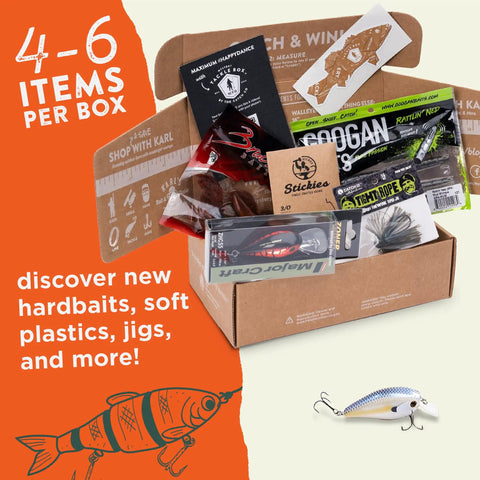 Mystery Tackle Box Freshwater Bass Lures Kit For Largemouth And Smallmouth with jigs, crankbaits, soft plastics, and magazine displayed.