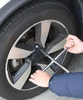 Using the 14 Inch Cross Lug Wrench With 4 Way Sockets for easy tire changes, demonstrating max torque on a stubborn lug nut.