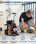 Heavy Duty 450 Watt Electric Drain Auger Machine Featuring 1850 RPM Motor Power And Extended One Hundred Foot Solid Steel Cable For Smoking The Toughest Clogs And Keeping Drains Running Fresh At Home Or Job Site, shown in use clearing a drain.