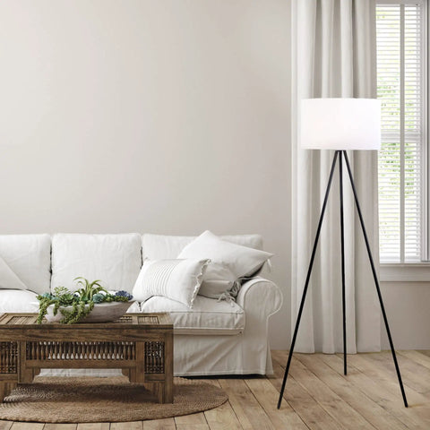Mid Century Modern Tripod Floor Lamp In Black, Tall Standing Lamp with Adjustable Three Way Lighting next to a sofa in a living room