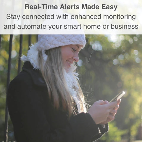 Person outdoors looking at smartphone for real-time alerts, surrounded by greenery, wearing a winter hat and coat. Text overlay about enhanced monitoring.