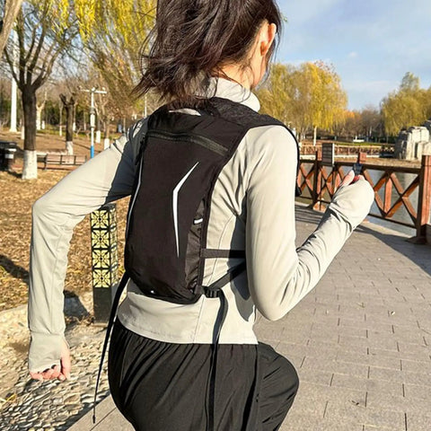 Runner wearing hydration running backpack with water reservoir vest lightweight pouch pack for runners waterproof storage