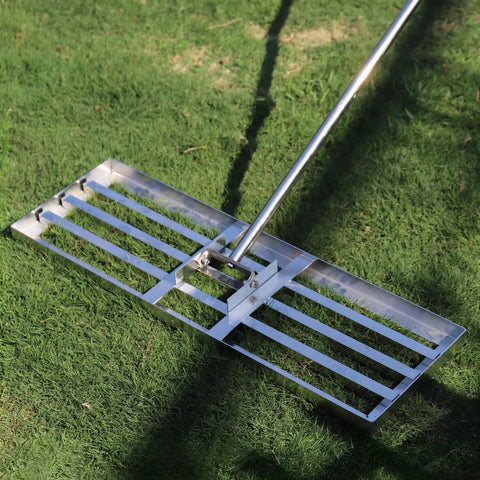 Heavy Duty Lawn Leveler Rake With 304 Stainless Steel Head, 30 Inch Wide, 6.5 Foot Ergonomic Handle resting on grass