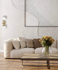 Celestia 2-Light Wall Sconce in matte brass with frosted glass shades in glamorous living room setting with modern decor.