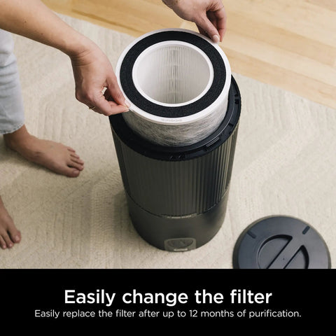 Person replacing filter in an HP200 Series air purifier, showcasing easy install of Replacement Filter For HP200 Series Air Purifiers With True HEPA Anti Allergen Filtration Odor Guard And VOC Protection Easy Install White Color Keeps Your Air Fresh And Clean.