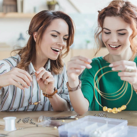 Women creating jewelry using 120 Pcs Memory Wire End Caps Set In Stainless Steel, Half Drilled Cord End Beads 3mm 4mm 5mm, Silver
