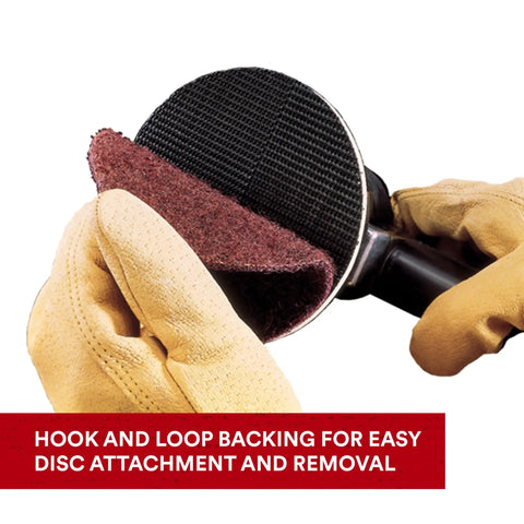 2 Inch Nonwoven Surface Conditioning Disc Medium Grit For Cleaning Finishing Blending And Light Deburring Open Web Material Runs Cooler Resists Loading And Will Not Gouge 25 Per Carton with hook and loop backing being attached to tool by gloved hand.