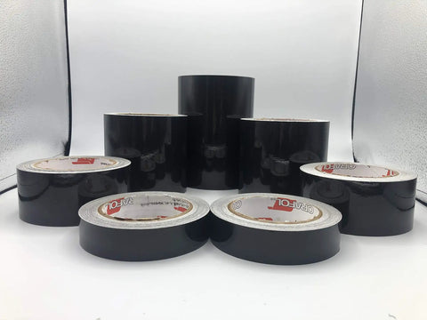 Straight Up Black Engineer Grade Reflective Tape That Goes Hard On Worksite Safety For Pipes And Bollards Smooth Flat Or Round Surfaces With Peel Off Acrylic Backing rolls arranged on display.