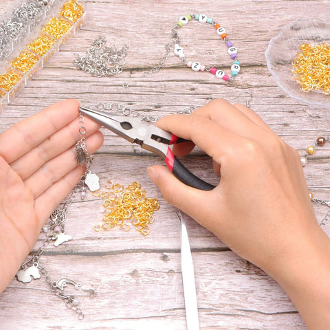 Person using pliers on jewelry piece with Jump Ring Kit For Jewelry Making With 1200 Open Jump Rings And Clasp Set, Necklace And Bracelet Repair Supplies, Includes Pliers And Tweezers In Gold And Silver