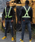 Man wearing high visibility reflective running vest pack of 10 neon yellow lightweight adjustable with reflective strips outdoors.